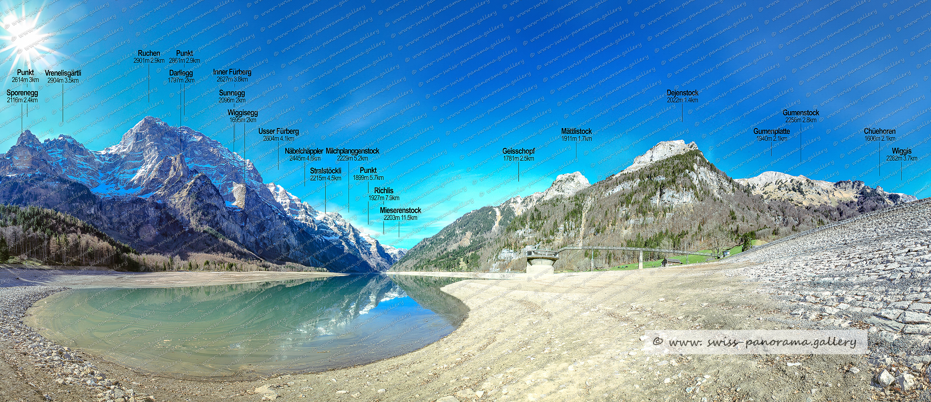 Klöntalersee bei niedrigem Wasserstand, Beschriftetes Alpenpanorama vom Klöntalersee, Vrenelisgärtli 2904m, Ruchen 2901m, Punkt 2616 Höchtor 2503m, Geisschopf 1781m  (Klöntal), Wiggisegg 1695m  (Glärnisch), Usser Fürberg 2604m, Sporenegg 2116m    (Glärnisch), Sunnegg 2096m , Inner Fürberg 2627m , Näbelchäppler 2445m, Stralstöggli 2215m (Stralstöckli)    , Mättlistock 1911m 1.7km. Milchplanggenstock 2229m, Mieserenstock 2203m, Dejenstock 2022m     (Klöntal), Gumenstock 2256m, Gumenplatte 1940m, Richlis 1927m, Chuehoren 1606m, Wiggis 2282m 3.7km,